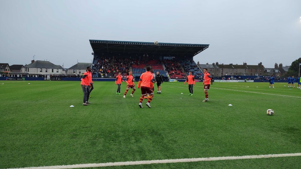 The Motherwell substitutes doing their half time rondos in front of the main stand at Links Park.